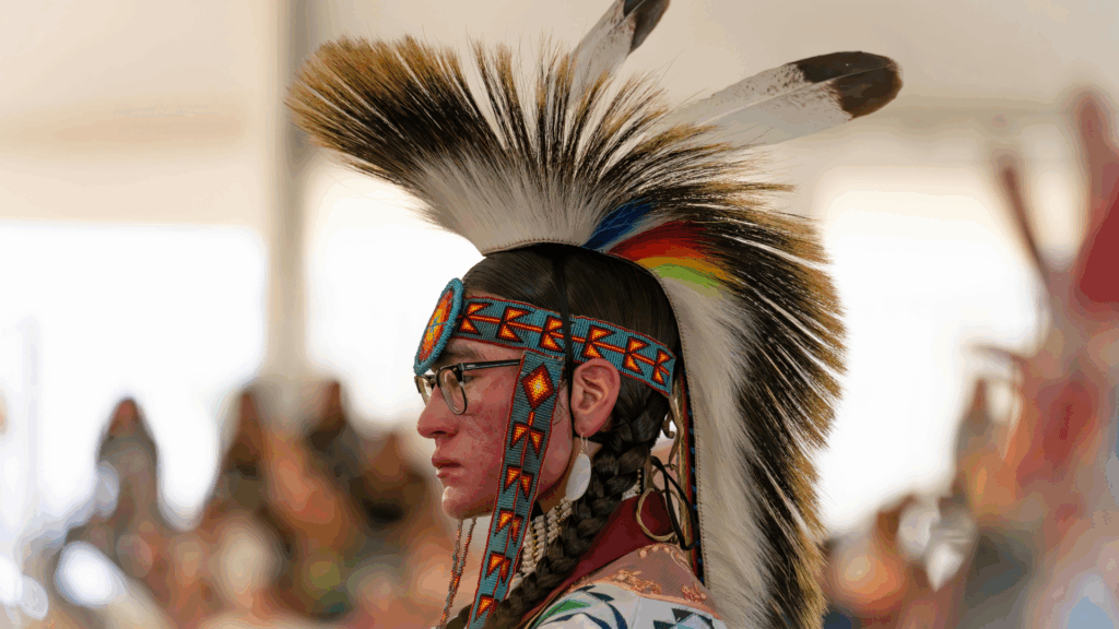 Indigenous ceremonial participant wearing traditional regalia, representing the cultural and spiritual traditions connected to peyote use among Native American communities